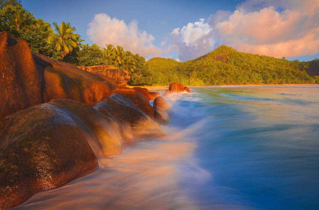 Sunset over crashing waves on Baie Lazare, Seychelles
