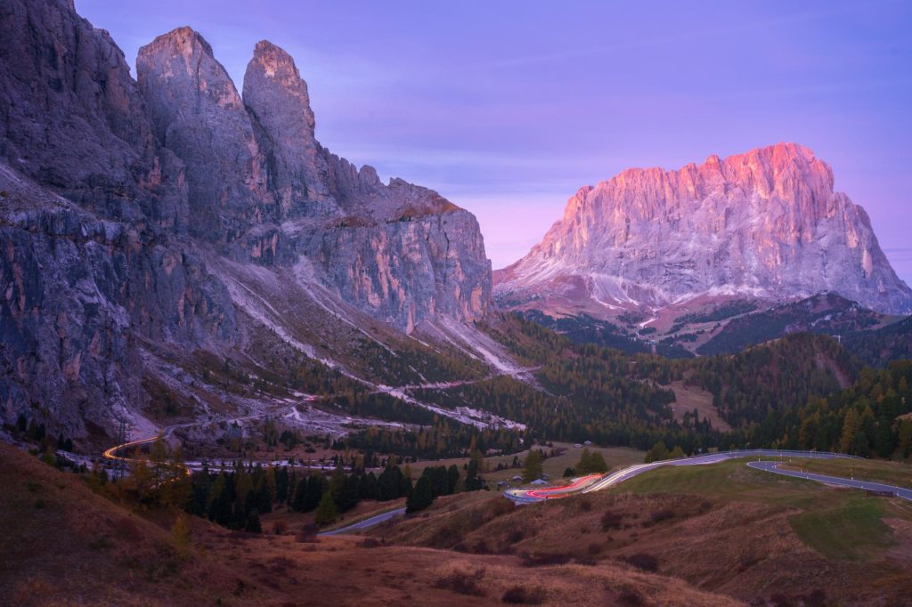 Gardena Pass at sunrise with mountains and winding road, Dolomites, Italy