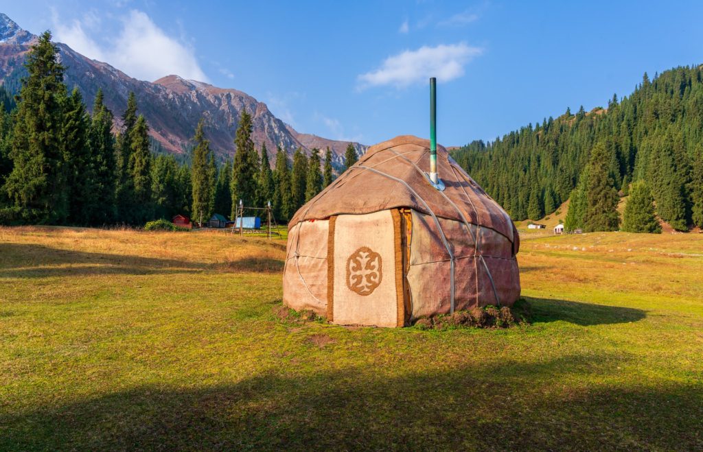 Yurt camp in Jeti-Oguz, Kyrgyzstan, surrounded by mountains and trees
