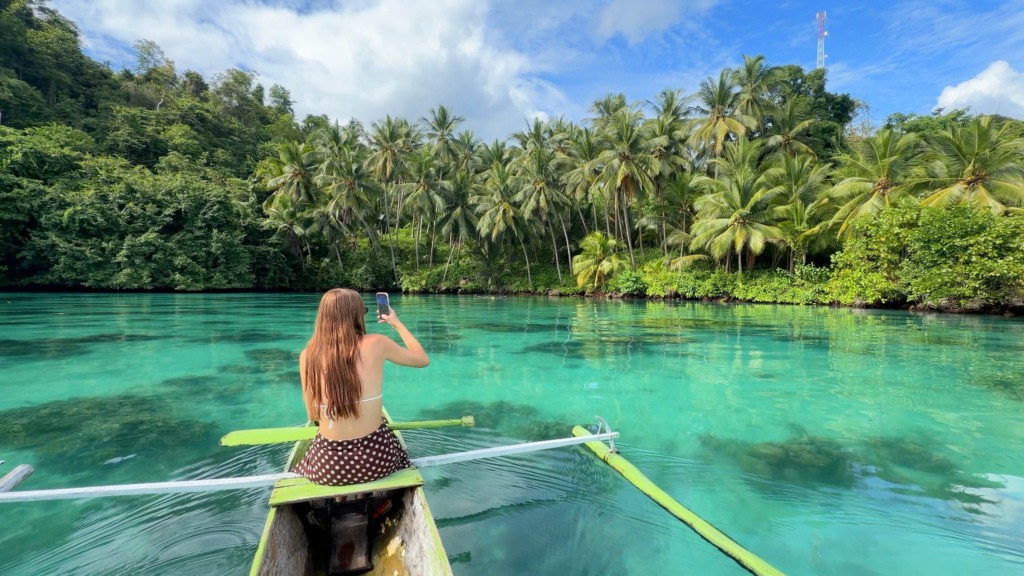Exploring the coastline of Kuwala Bay by outrigger boat