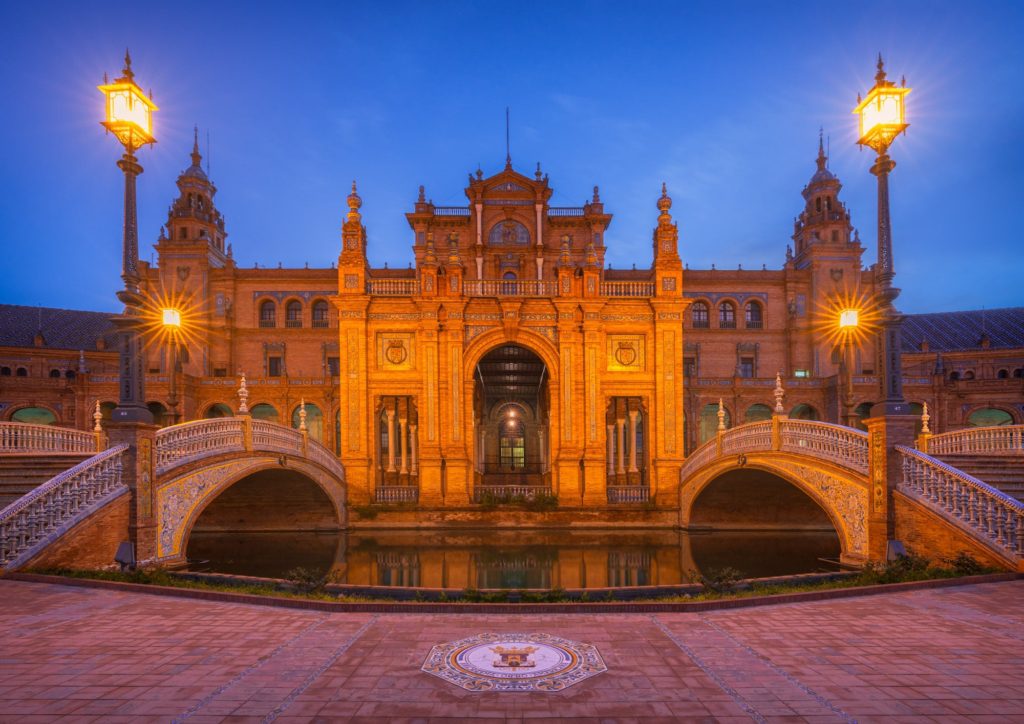 Plaza de España at dusk, showcasing symmetrical architecture and bridges, Seville, Spain