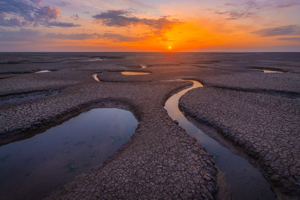 Sunset over low tide mudflats at Snettisham, Norfolk, England