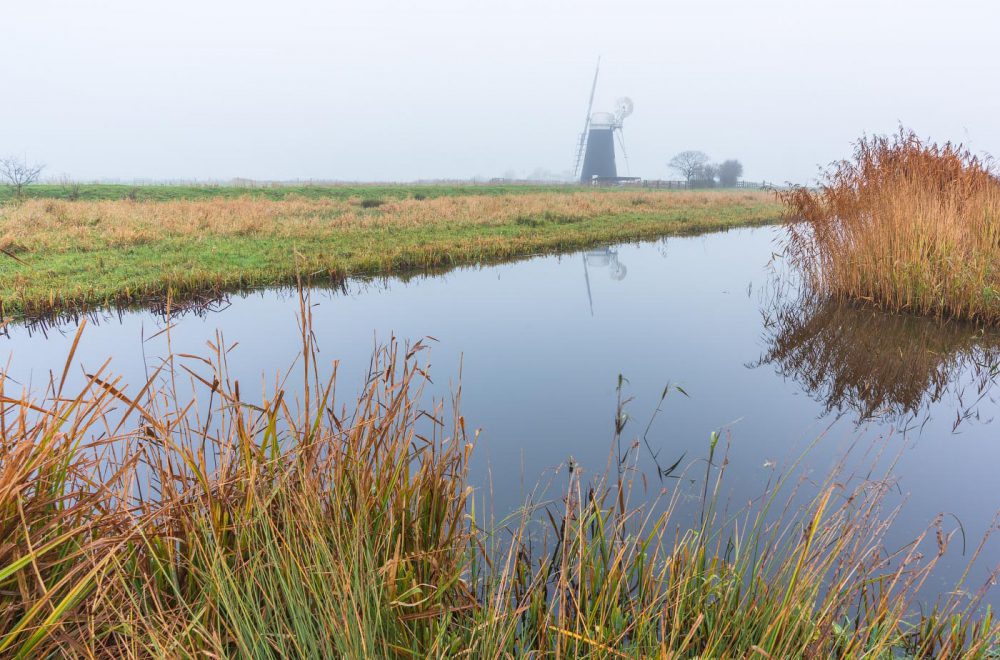 Windmill Halvergate Marshes, Norfolk, amid a foggy morning