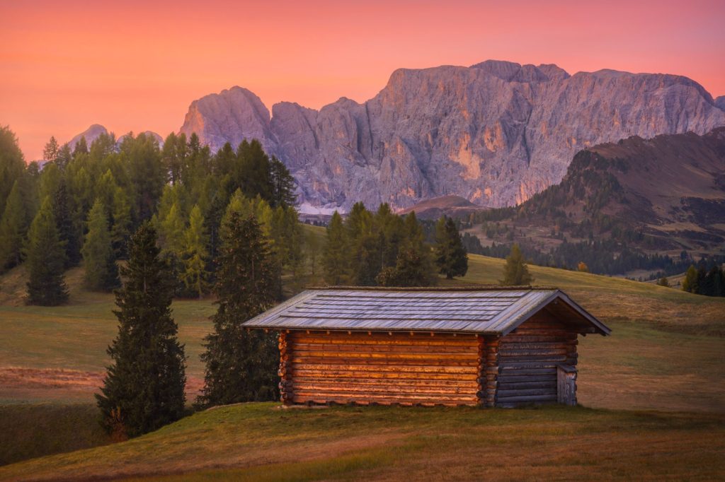 Alpe di Siusi at sunrise with colourful autumn hues and mountains