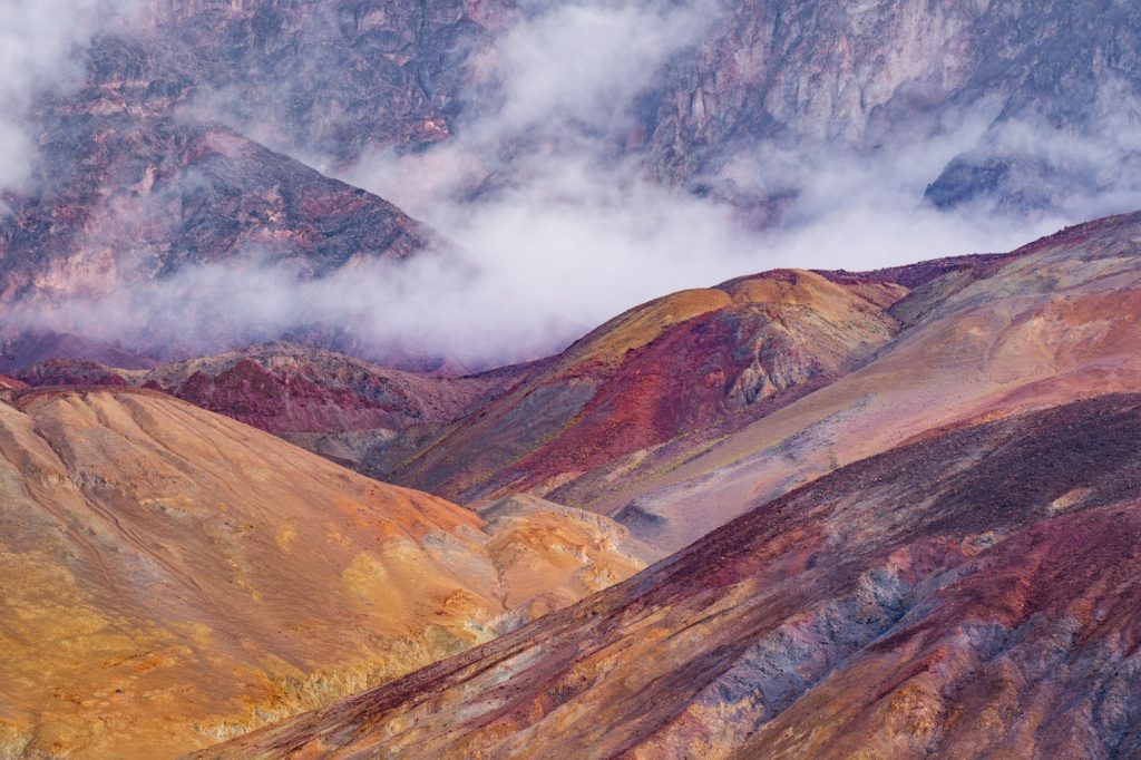 Colourful mountain landscape shrouded in clouds, Death Valley, USA