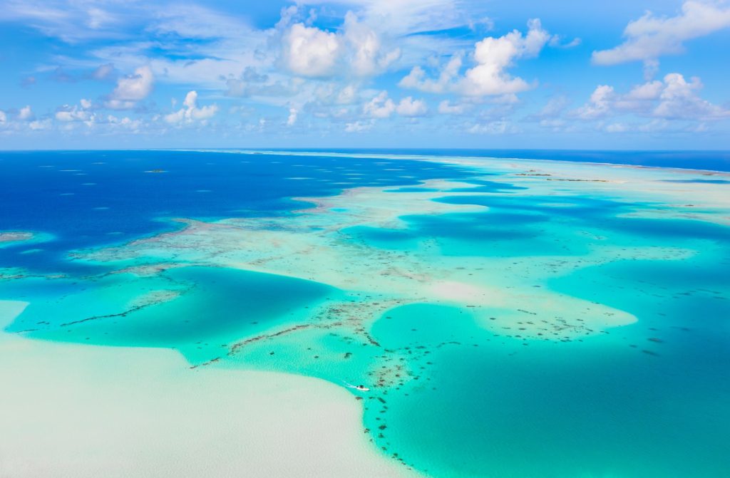 Aerial view of a vibrant atoll in turquoise waters
