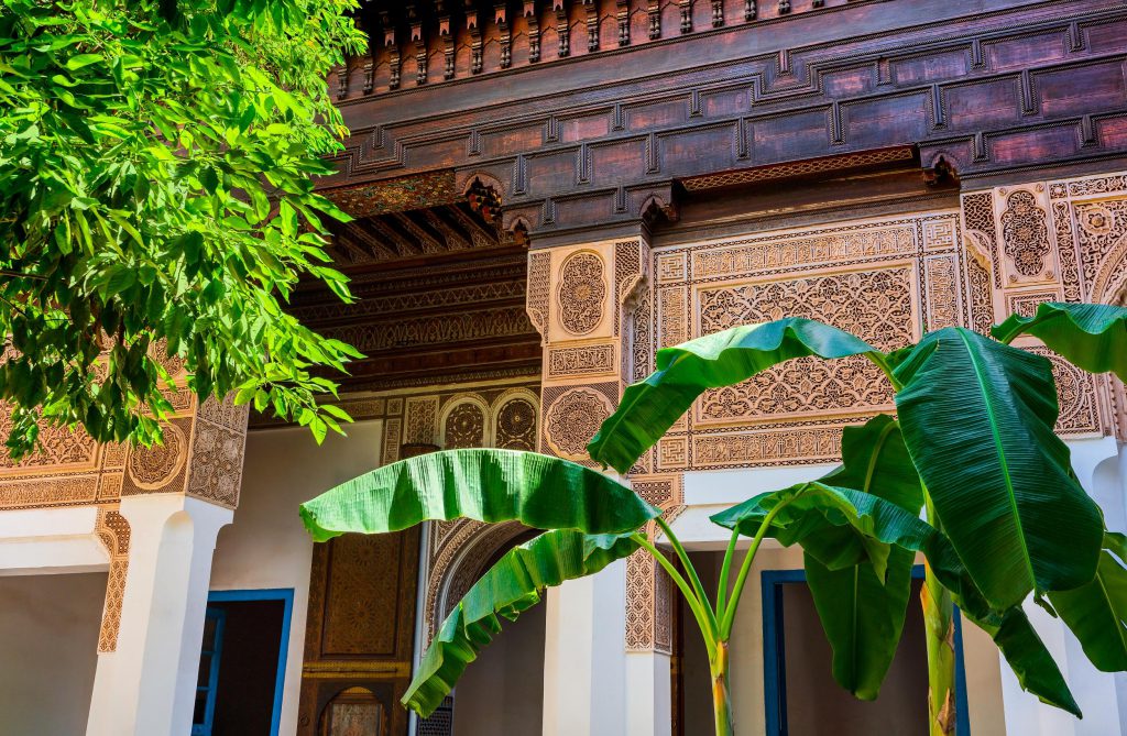 Intricate architecture and lush greenery at Bahia Palace, Marrakesh, Morocco