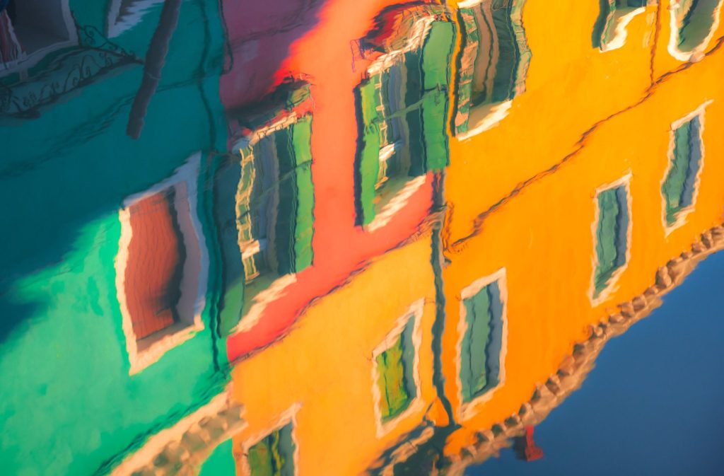 Colourful reflections of buildings in Burano, Venice, Italy
