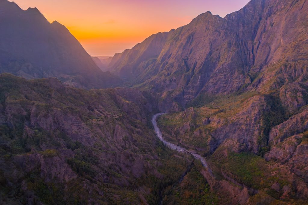 Cilaos Valley at sunset, Réunion Island showcasing dramatic mountains and river