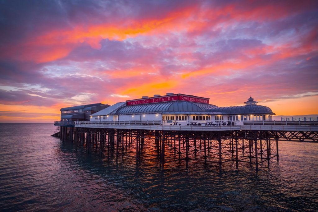 Cromer Pier at dawn with vibrant sunrise colours, Norfolk, England