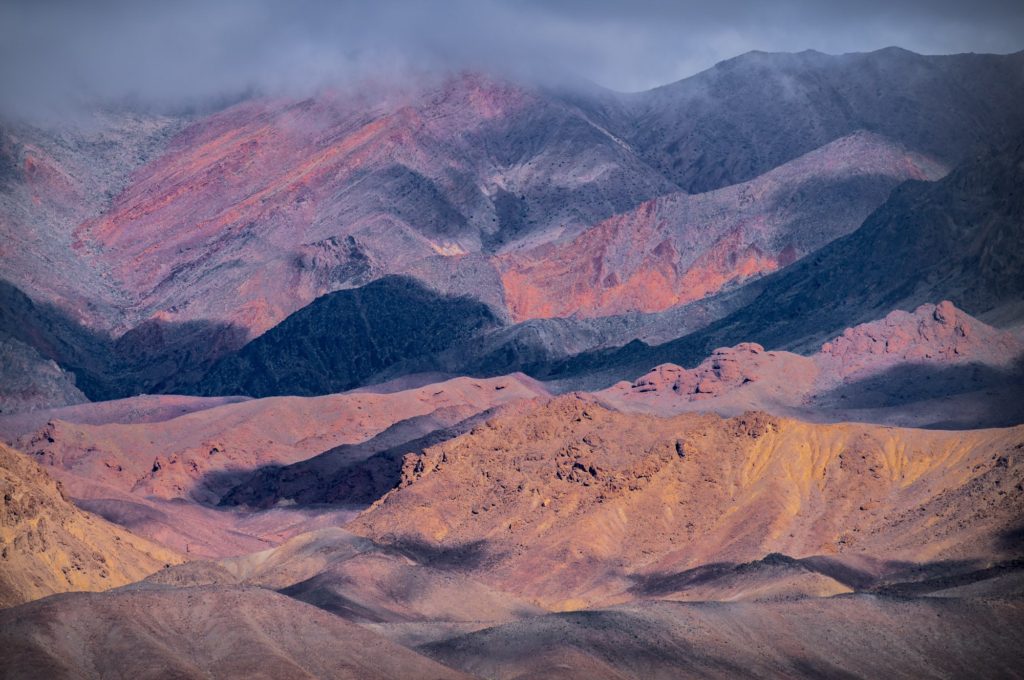 Afternoon light illuminating colourful mountains in Death Valley, USA