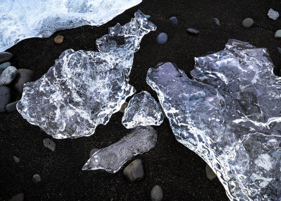 Clear ice formations on black sand at Diamond Beach, Iceland