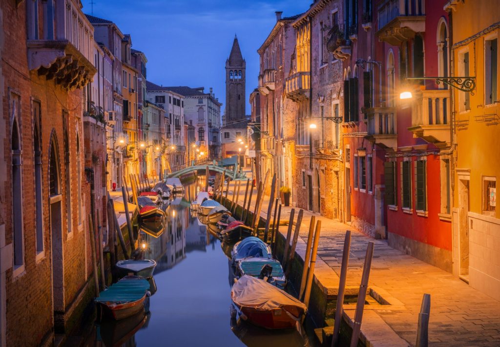 Twilight canals lined with colourful buildings in Venice, Italy