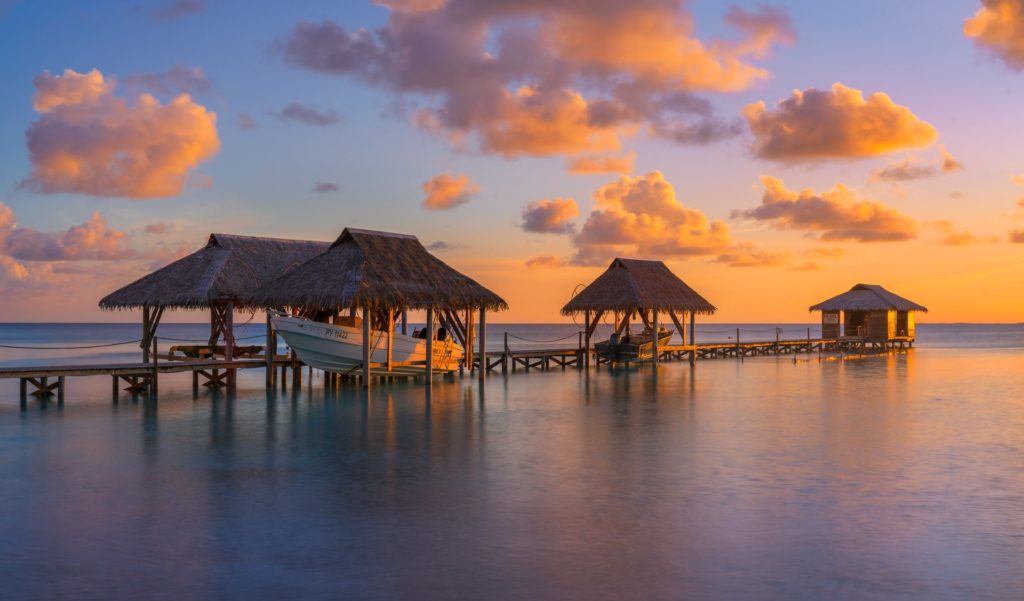 Sunset over Fakarava's overwater bungalows, French Polynesia