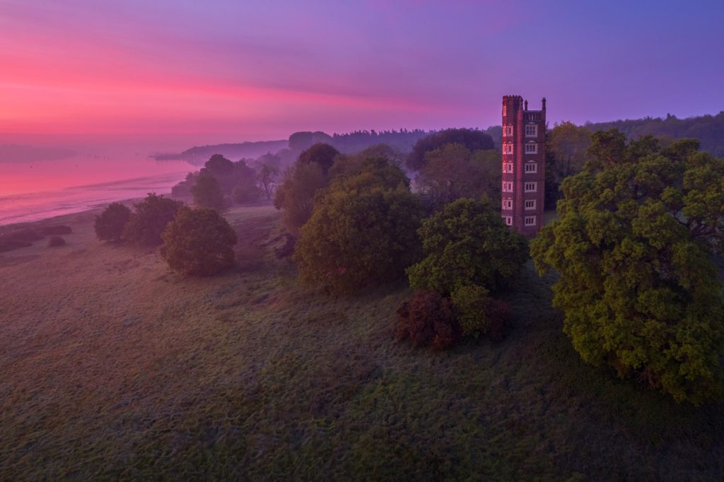 Freston Tower surrounded by trees at sunrise, Suffolk, England