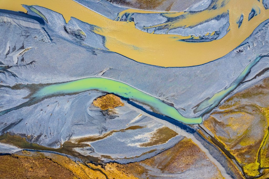 Vibrant glacier rivers flowing through Iceland's rugged landscape
