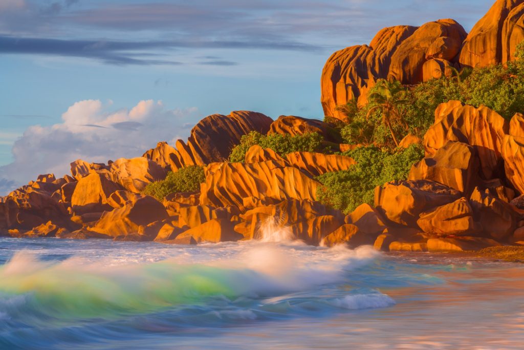 Crashing waves on rocky shoreline at Grand Anse, La Digue, Seychelles