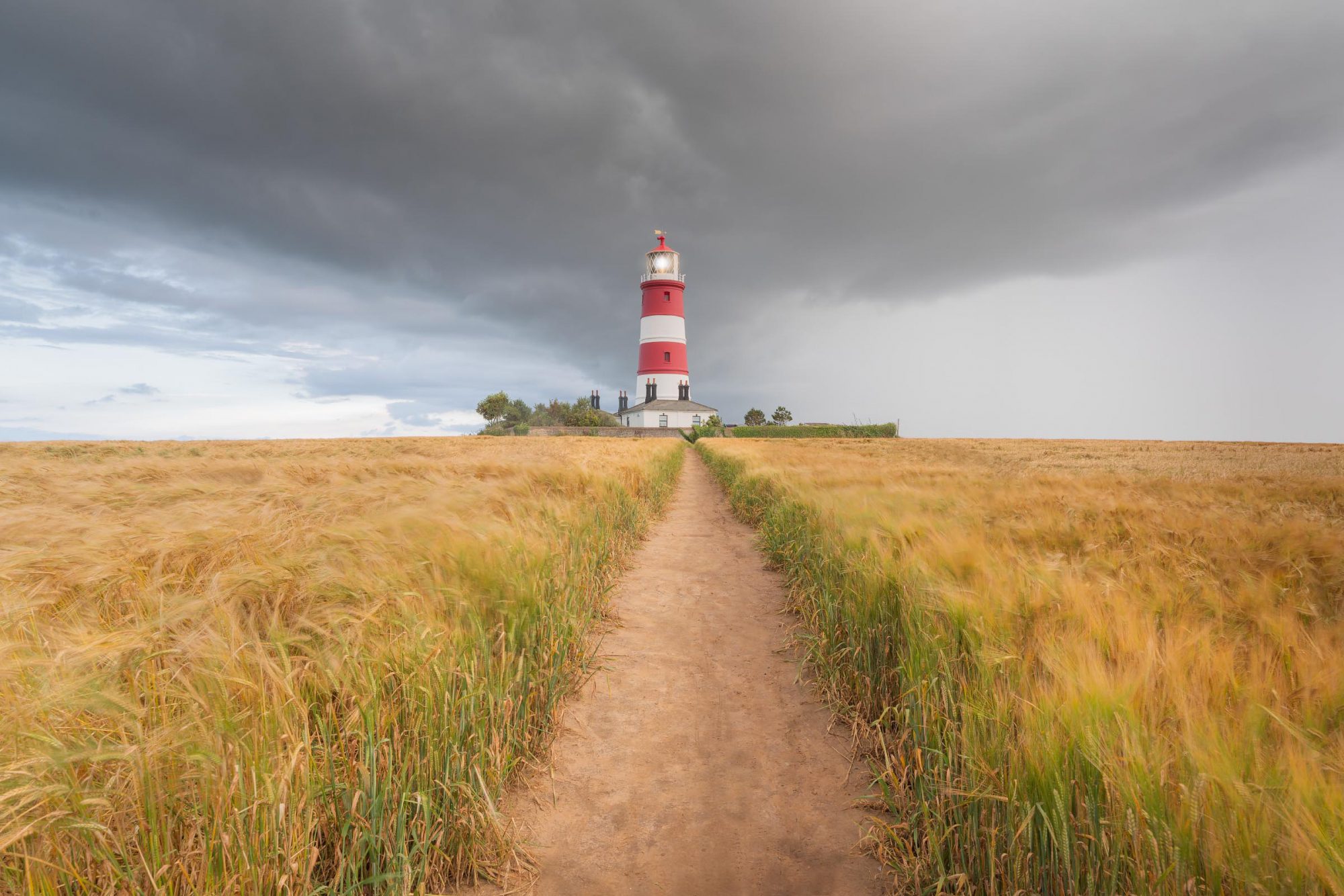Lighthouse in Happisburgh, Norfolk, as a storm approaches on a summer evening