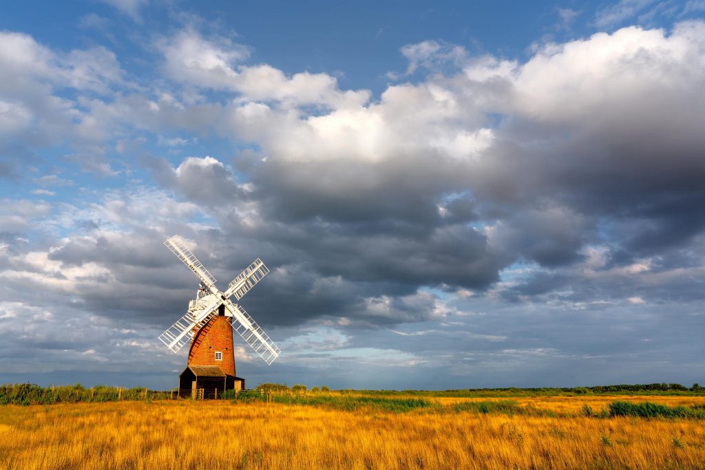 Horsey Windmill under dramatic clouds, Norfolk, England