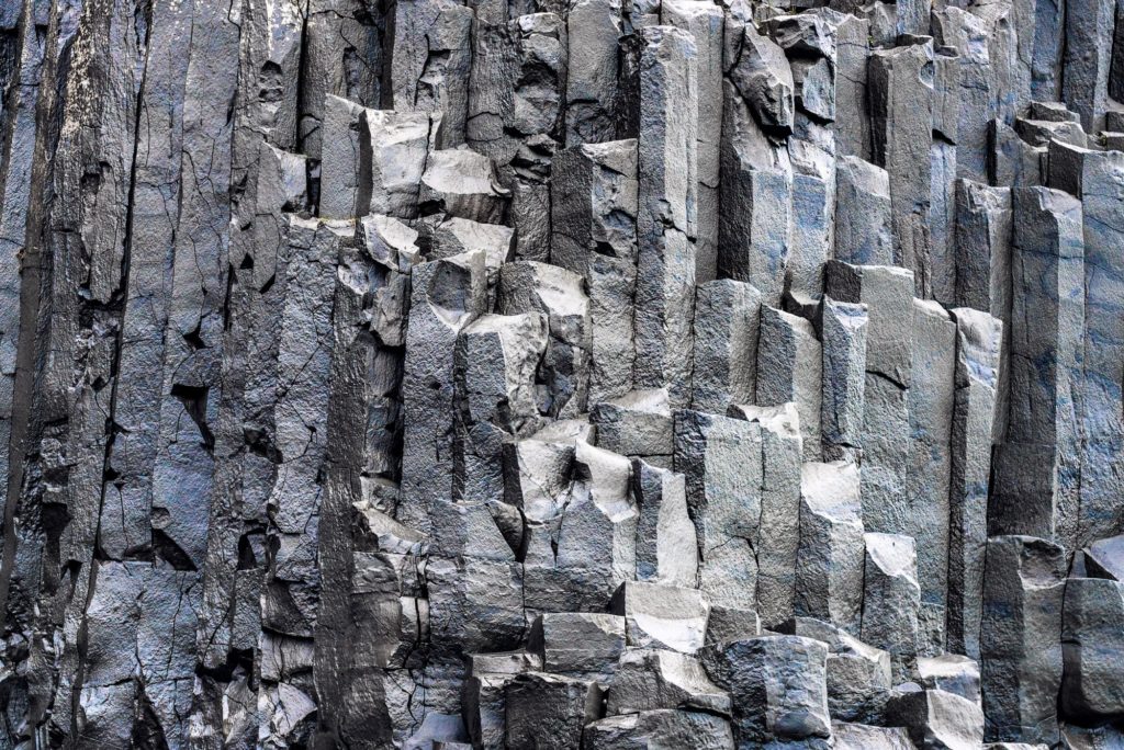 Hexagonal basalt rock formations at a beach in Iceland
