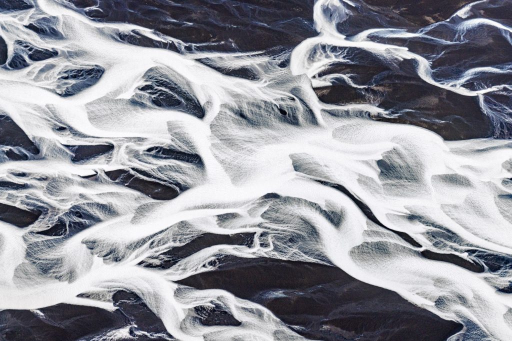 Intricate river patterns on a dark landscape in Iceland