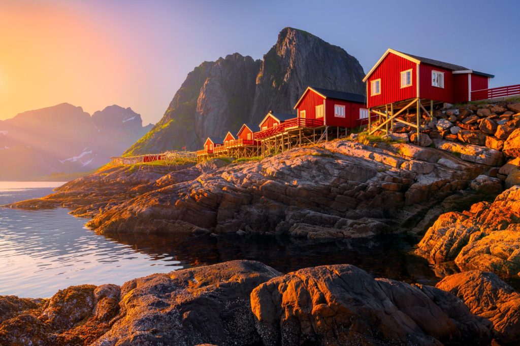 Red fisherman houses on stilts by the water in Reine, Lofoten, Norway