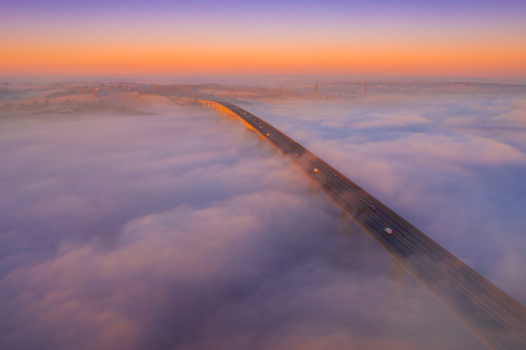 Orwell Bridge shrouded in fog at sunrise, Ipswich, Suffolk, England