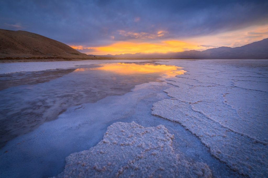 Sunset reflecting on salt flats in Death Valley, USA