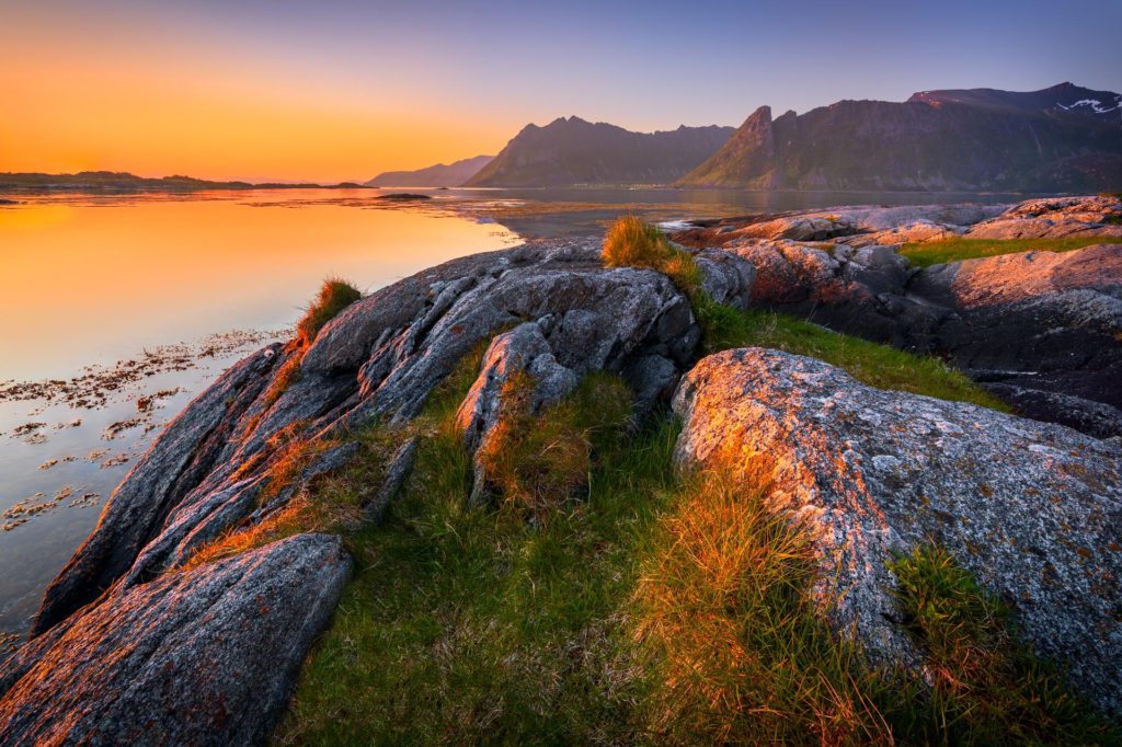 Midnight sun illuminating rocky beach in Lofoten, Norway