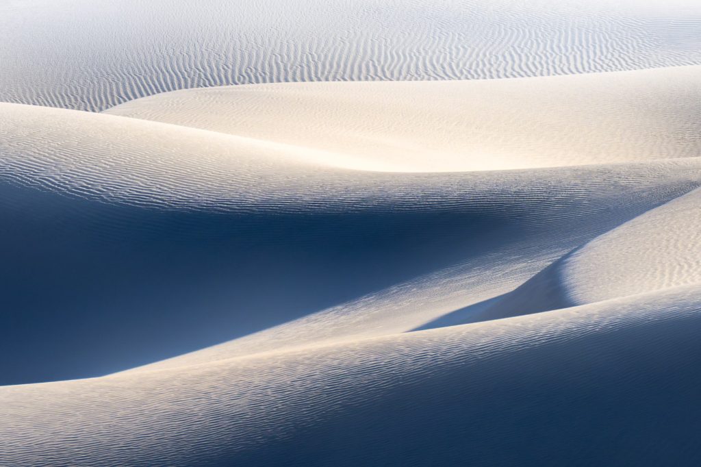 Mesquite Dunes in Death Valley, USA, showcasing abstract sand patterns under midday sun