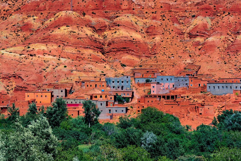 Vibrant Moroccan valleys featuring colourful houses against red hills