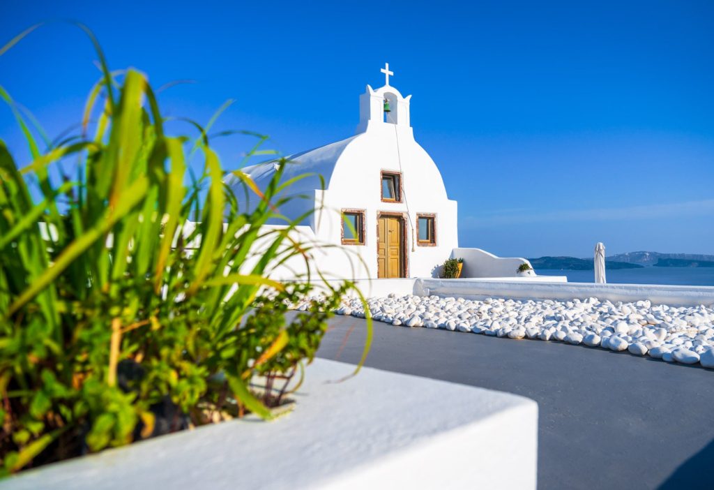 Whitewashed hotel with a cross in Oia, Santorini, Greece