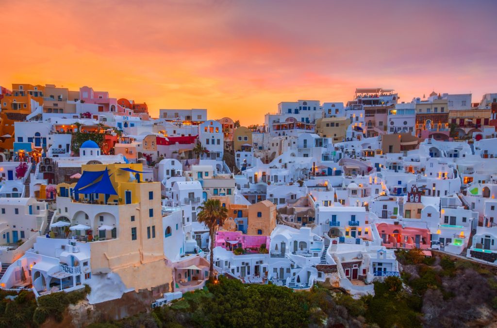 Sunset over Oia's whitewashed buildings, Santorini, Greece