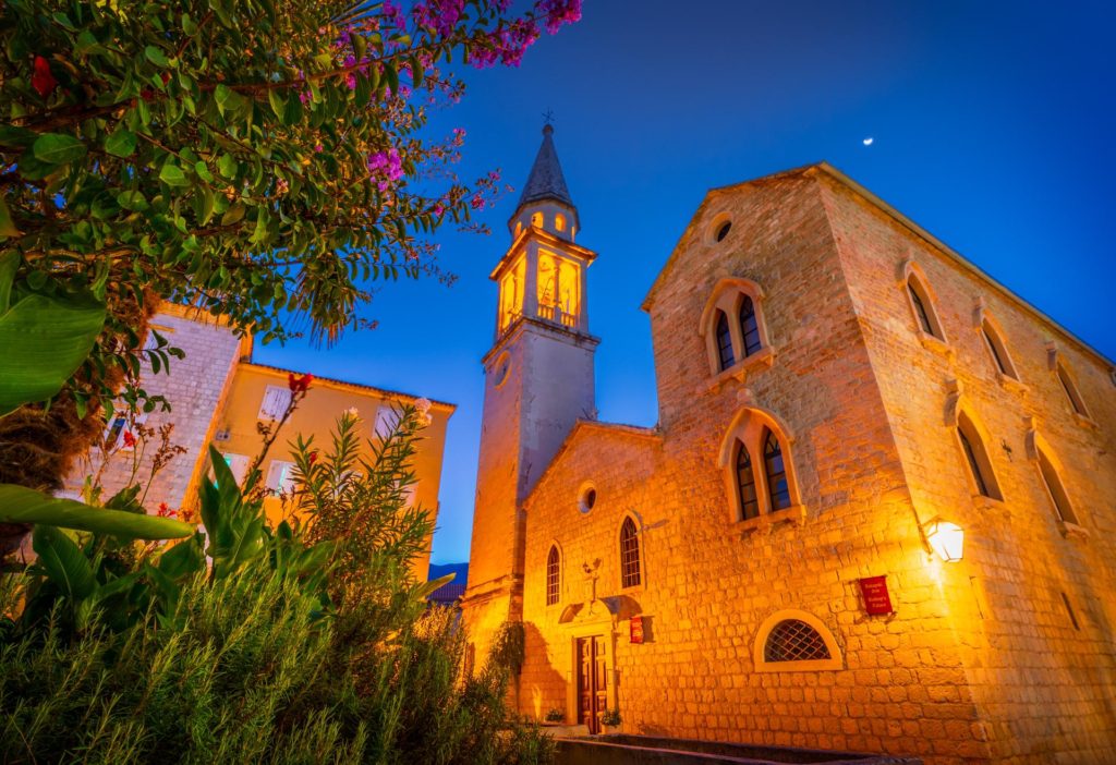 Historic buildings illuminated at dusk in Budva, Montenegro