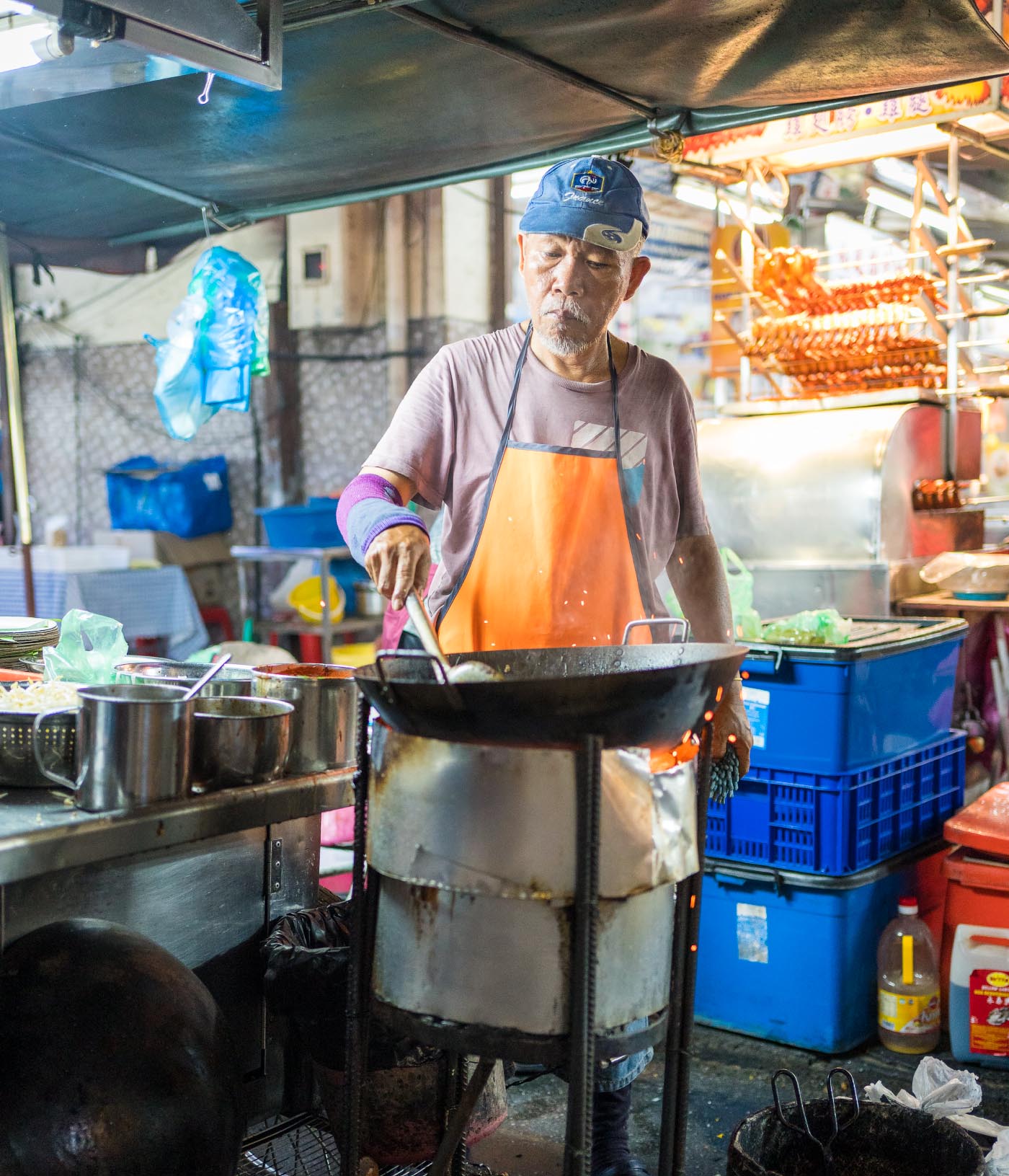 Chef on a food street market in Penange, Malaysia, cooking