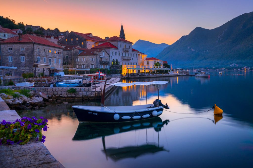 Sunrise over Perast, Montenegro with boats in calm waters