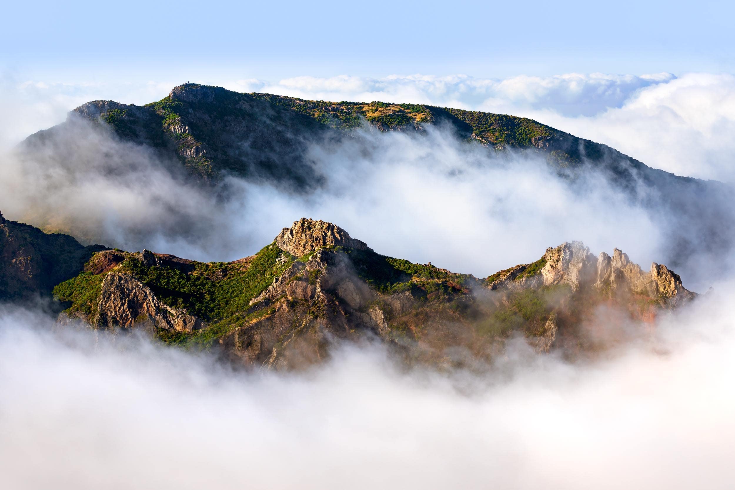 Mountain peaks shrouded in clouds at Pico do Areeiro, Madeira, Portugal