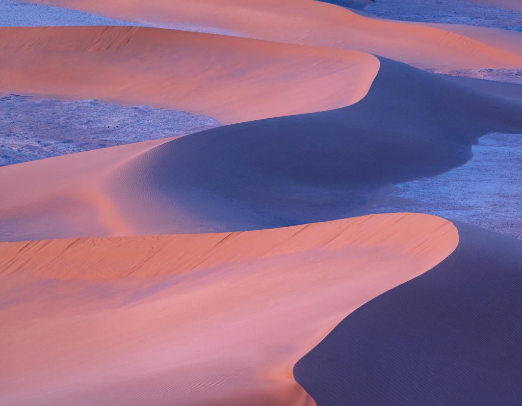 Waves of sand dunes at sunset in the Sahara Desert, Morocco