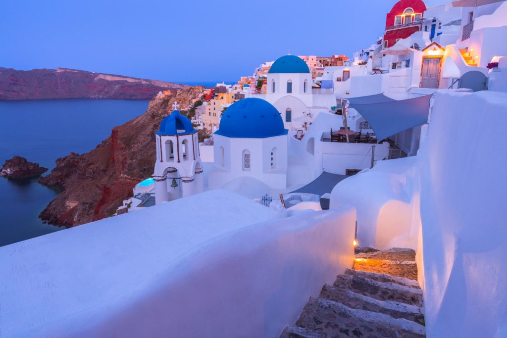 Santorini's white buildings and blue domes at twilight, Greece
