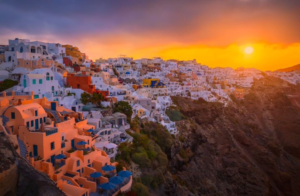 Sunrise illuminating colourful buildings on Santorini, Greece