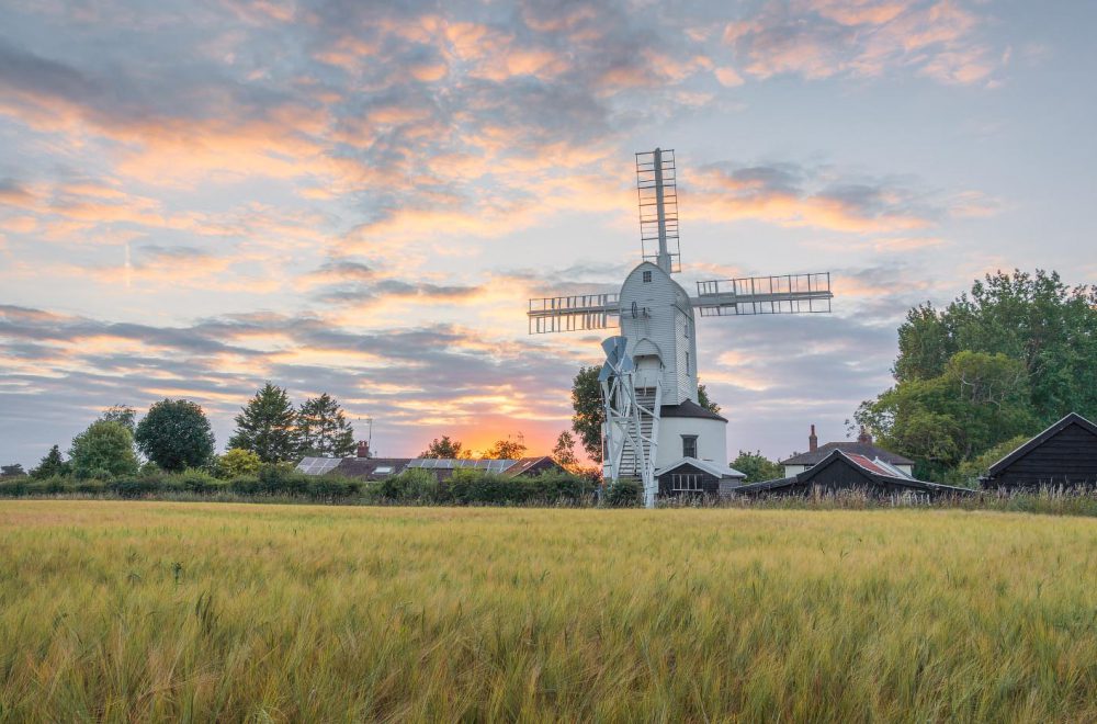 Saxtead Green Post Mill on a summer evening with colour sunset in the background