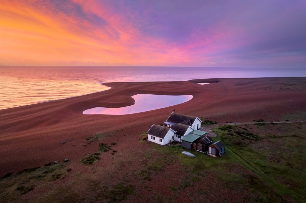 Sunrise over Shingle Street, Suffolk, with vibrant sky and calm sea