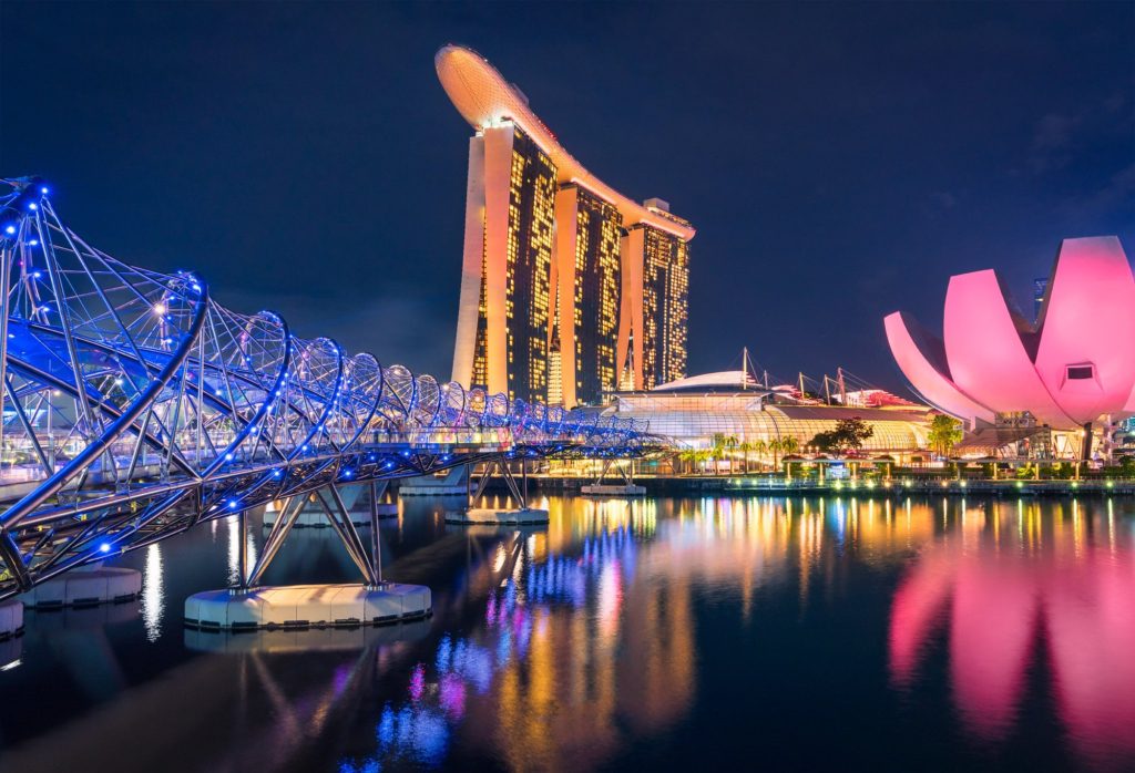 Singapore Flyer illuminated at night with Marina Bay Sands in background