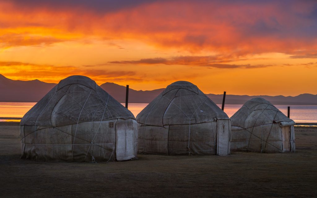 Three yurts at sunset by Song Kul Lake, Kyrgyzstan