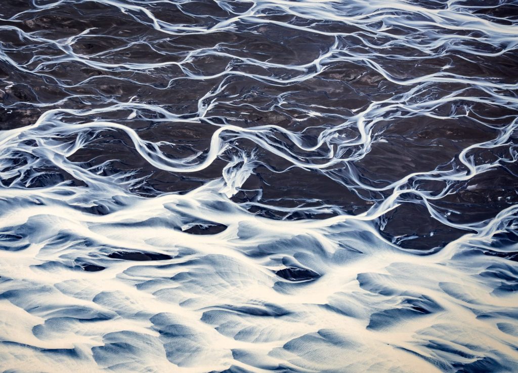 Glacial rivers meandering through the black sands of South Iceland