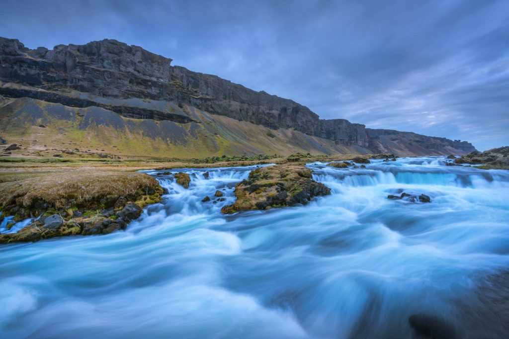 Turquoise river flowing through rocky landscape in South Iceland