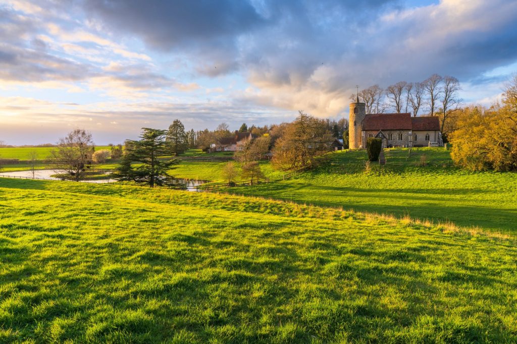 Stormy sunset over a green landscape in Suffolk, England