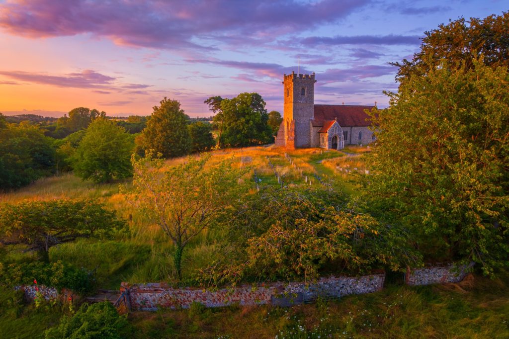 Stowmarket church surrounded by trees at sunset, Suffolk, England