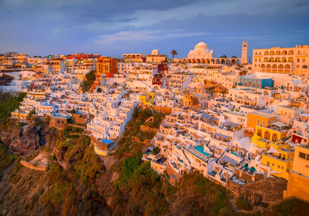 Aerial view of Santorini's white buildings at sunset, Greece