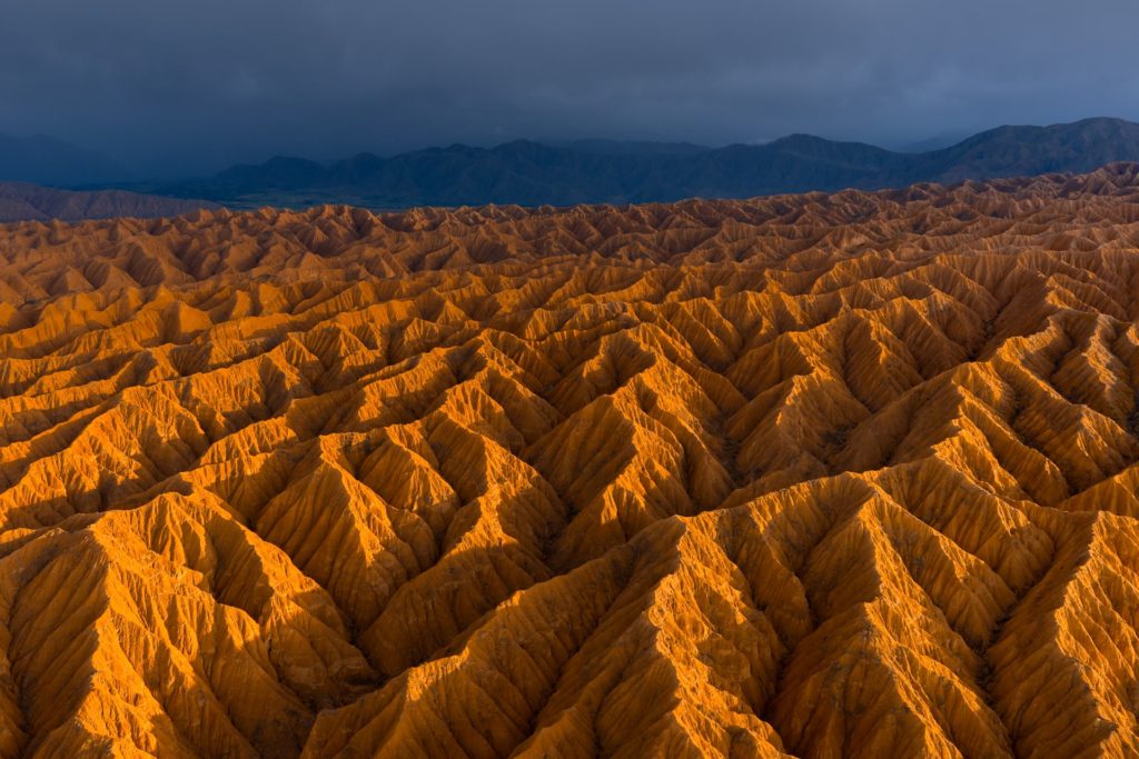 Vibrant orange ridges in the Valley of Forgotten Rivers, Kyrgyzstan